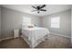 Cozy bedroom with a queen-size bed, nightstand, two windows, and a ceiling fan at 1507 Holly Rd, Lakeland, FL 33801
