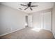 Neutral bedroom featuring a ceiling fan, carpet flooring, and a closet at 1507 Holly Rd, Lakeland, FL 33801