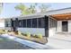 Charming single-story home featuring a screened porch and fresh landscaping at 1507 Holly Rd, Lakeland, FL 33801