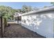 Side exterior showcasing white wall, AC units, and covered walkway to the main house at 1507 Holly Rd, Lakeland, FL 33801