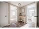Hallway view leading to bedroom and bathroom, with stylish console table at 1507 Holly Rd, Lakeland, FL 33801