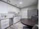 Bright kitchen with white cabinets, stainless steel appliances, granite counters and a stylish tile backsplash at 1507 Holly Rd, Lakeland, FL 33801