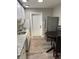 Compact kitchen with white cabinets, stainless steel appliances, and a dining area at 1507 Holly Rd, Lakeland, FL 33801