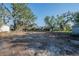 Cleared land available and ready to build, surrounded by established trees and fencing at 1507 Holly Rd, Lakeland, FL 33801