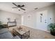 Bright living room with neutral paint, ceiling fan, and a view to the hallway at 1507 Holly Rd, Lakeland, FL 33801