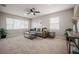 Spacious living room with a ceiling fan, neutral carpet, and ample natural light at 1507 Holly Rd, Lakeland, FL 33801