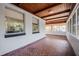 View of the covered porch featuring mosaic tile floors and natural wood ceiling at 1507 Holly Rd, Lakeland, FL 33801