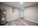 Utility room showcasing light grey walls, modern grey flooring, water heater, and electrical panel at 1507 Holly Rd, Lakeland, FL 33801