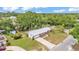 Aerial view of the home showcases its landscaped yard, long driveway and overall curb appeal at 1507 Neptune Dr, Lakeland, FL 33801