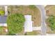 Aerial view of a house with a driveway, lush green tree in the front yard, and a metal roof at 1507 Neptune Dr, Lakeland, FL 33801