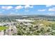 Scenic aerial view of a community with a lake, green spaces, homes, commercial buildings, and beautiful cloudscape at 1507 Neptune Dr, Lakeland, FL 33801