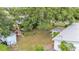 Overhead shot of the home set on a generous lot with mature trees and additional structures at 1507 Neptune Dr, Lakeland, FL 33801