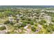 A nice aerial view of a neighborhood with mature trees, a nearby lake, and diverse housing styles at 1507 Neptune Dr, Lakeland, FL 33801