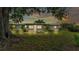 Backyard view showing a patio area and lush greenery, perfect for outdoor enjoyment and leisure at 1507 Neptune Dr, Lakeland, FL 33801
