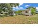 Large backyard featuring mature landscaping and a patio area for outdoor relaxation and entertaining at 1507 Neptune Dr, Lakeland, FL 33801