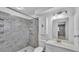 Well-lit bathroom with grey tiled shower, white sink, and a mirrored medicine cabinet at 1507 Neptune Dr, Lakeland, FL 33801