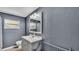 Grey bathroom features a vanity, toilet, and window at 1507 Neptune Dr, Lakeland, FL 33801