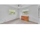 Bright bedroom with neutral tile floors and a dresser below dual windows at 1507 Neptune Dr, Lakeland, FL 33801