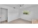 Another bright bedroom with neutral tile floors and a ceiling fan at 1507 Neptune Dr, Lakeland, FL 33801