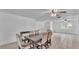 Open-concept dining area features tile floors, a ceiling fan, and a large wood table with upholstered chairs at 1507 Neptune Dr, Lakeland, FL 33801