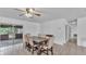 Well-lit dining room features a dark wood table, neutral tiling and a sliding glass door to a porch at 1507 Neptune Dr, Lakeland, FL 33801