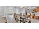 Open-concept dining area features tile floors, a ceiling fan, and a large wood table with upholstered chairs at 1507 Neptune Dr, Lakeland, FL 33801