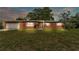 Charming brick home featuring a well-manicured lawn, attached garage, and traditional windows at 1507 Neptune Dr, Lakeland, FL 33801