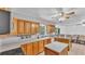 Kitchen features tile floors, wood cabinets, stainless steel appliances, ample counter space, and natural light at 1507 Neptune Dr, Lakeland, FL 33801