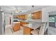 Kitchen features ample counter space, wooden cabinets, tile floors, and stainless steel appliances at 1507 Neptune Dr, Lakeland, FL 33801