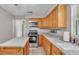 Kitchen features stainless steel appliances, tile floors, wood cabinets, and ample counter space at 1507 Neptune Dr, Lakeland, FL 33801