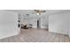 Spacious living room featuring neutral tile flooring, a ceiling fan and an adjacent dining room at 1507 Neptune Dr, Lakeland, FL 33801