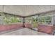 Enclosed patio featuring brick accents, multiple windows providing ample natural light, and tile flooring at 1507 Neptune Dr, Lakeland, FL 33801