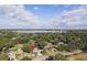 Aerial view highlighting the home's location near a lake, surrounded by lush greenery in a residential neighborhood at 1516 Jae Pl, Lakeland, FL 33803