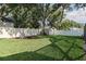 Landscaped backyard featuring a well-maintained lawn, privacy fence, and cozy seating area at 1516 Jae Pl, Lakeland, FL 33803