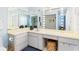 Bright bathroom featuring large mirrors with Hollywood-style lighting and ample counter space, plus a walk-in shower at 1516 Jae Pl, Lakeland, FL 33803