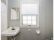 Modest bathroom with a vintage sink, window, and simple decor, perfect for a guest or secondary bathroom at 1516 Jae Pl, Lakeland, FL 33803