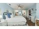 Spacious primary bedroom with a ceiling fan, blue accent walls, a stylish desk, and double closets at 1516 Jae Pl, Lakeland, FL 33803