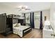 Cozy bedroom with a fun bunk bed, ceiling fan, desk, and large window, perfect for play and rest at 1516 Jae Pl, Lakeland, FL 33803