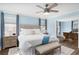 Inviting bedroom featuring a comfortable bed, bench, and a glimpse into the adjacent office at 1516 Jae Pl, Lakeland, FL 33803