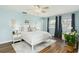 Bright bedroom featuring a ceiling fan, blue walls and coordinating curtains at 1516 Jae Pl, Lakeland, FL 33803