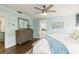 Tranquil bedroom with en suite bathroom, wood floors and a stylish ceiling fan at 1516 Jae Pl, Lakeland, FL 33803