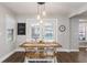 Cozy dining area with a rustic wooden table, bench seating, pendant lighting, and access to the backyard at 1516 Jae Pl, Lakeland, FL 33803