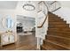 Grand foyer with a curved staircase, hardwood floors, and elegant decor at 1516 Jae Pl, Lakeland, FL 33803