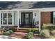 Inviting front porch with brick steps, stylish decor, and a welcoming ambiance at 1516 Jae Pl, Lakeland, FL 33803
