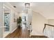 Well-lit hallway featuring hardwood floors, a view of the upstairs bathroom, and staircase at 1516 Jae Pl, Lakeland, FL 33803