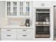 Well-appointed kitchen with stainless steel double ovens, a coffee station, and stylish cabinets at 1516 Jae Pl, Lakeland, FL 33803