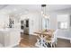 Eat-in kitchen featuring modern stainless steel appliances, bright natural light, and a farmhouse dining table at 1516 Jae Pl, Lakeland, FL 33803