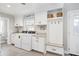 Spacious laundry room featuring a washer, dryer, built-in storage, and mudroom area at 1516 Jae Pl, Lakeland, FL 33803