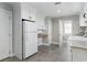 Utility room with modern appliances, built-in cabinets, counter space, and gray tile flooring at 1516 Jae Pl, Lakeland, FL 33803