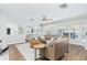 Open-concept living room with hardwood floors, large windows, and seamless flow to the kitchen at 1516 Jae Pl, Lakeland, FL 33803